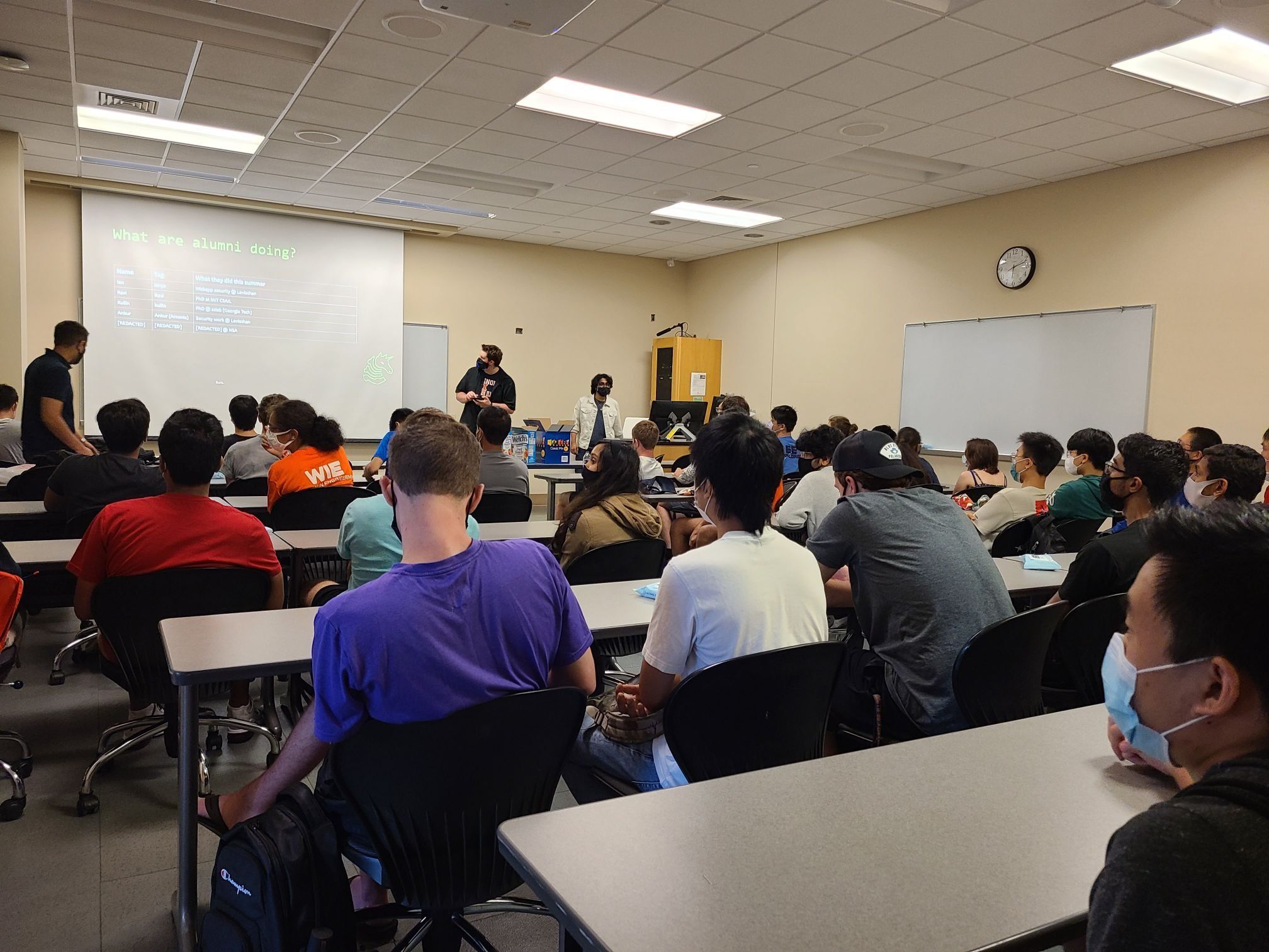 Another angle of the packed room of students interested in SIGPwny from the back, showing the presenters